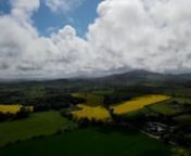 Drone footage of rural County Wicklow, Ireland. Featuring oil seed rape, hay bales, Irish Sea, sea mist, fields. 4K.