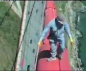 A crazy bridge engineer decides to hang over the edge of the bridge, hundreds of feet in the air, without any supports or harness.