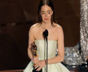 Oscar-winning actress Emma Stone had to be &#39;sewn back into&#39; her Louis Vuitton gown after she was forced to get up on stage to pick up herprize with a broken zipper which she had &#39;busted&#39; during Ryan Gosling&#39;s performance of &#39;I&#39;m Just Ken&#39;.