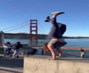 This woman performed a handstand near an iconic bridge. She did a handstand on a bench and walked in the air with her legs up there.&#60;br/&#62;&#60;br/&#62;The underlying music rights are not available for license. For use of the video with the track(s) contained therein, please contact the music publisher(s) or relevant rightsholder(s).
